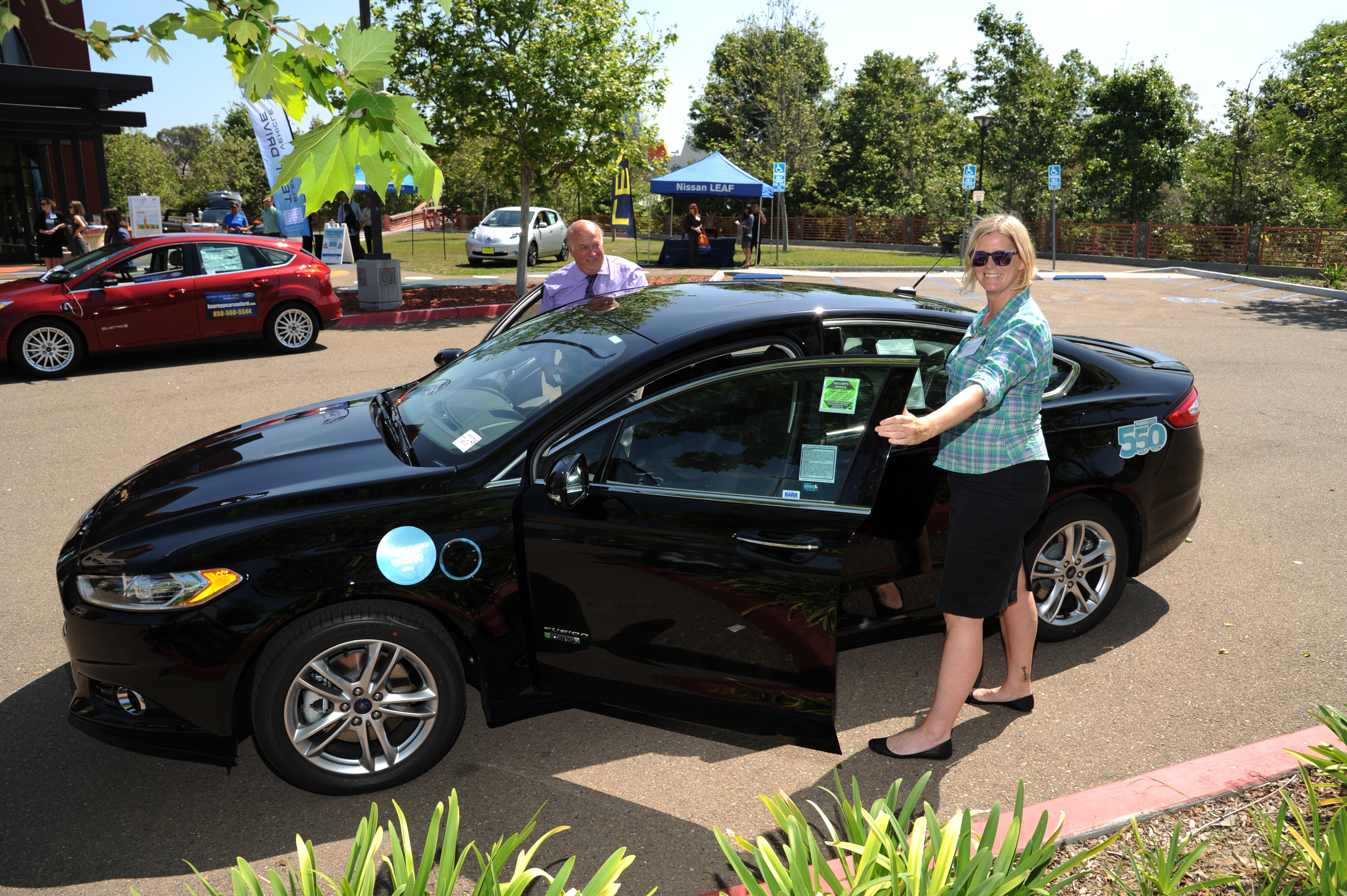 People standing next to a car