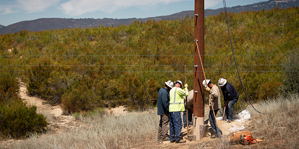 Service techs installing pole 2