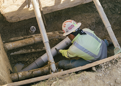 Service tech laying pipes