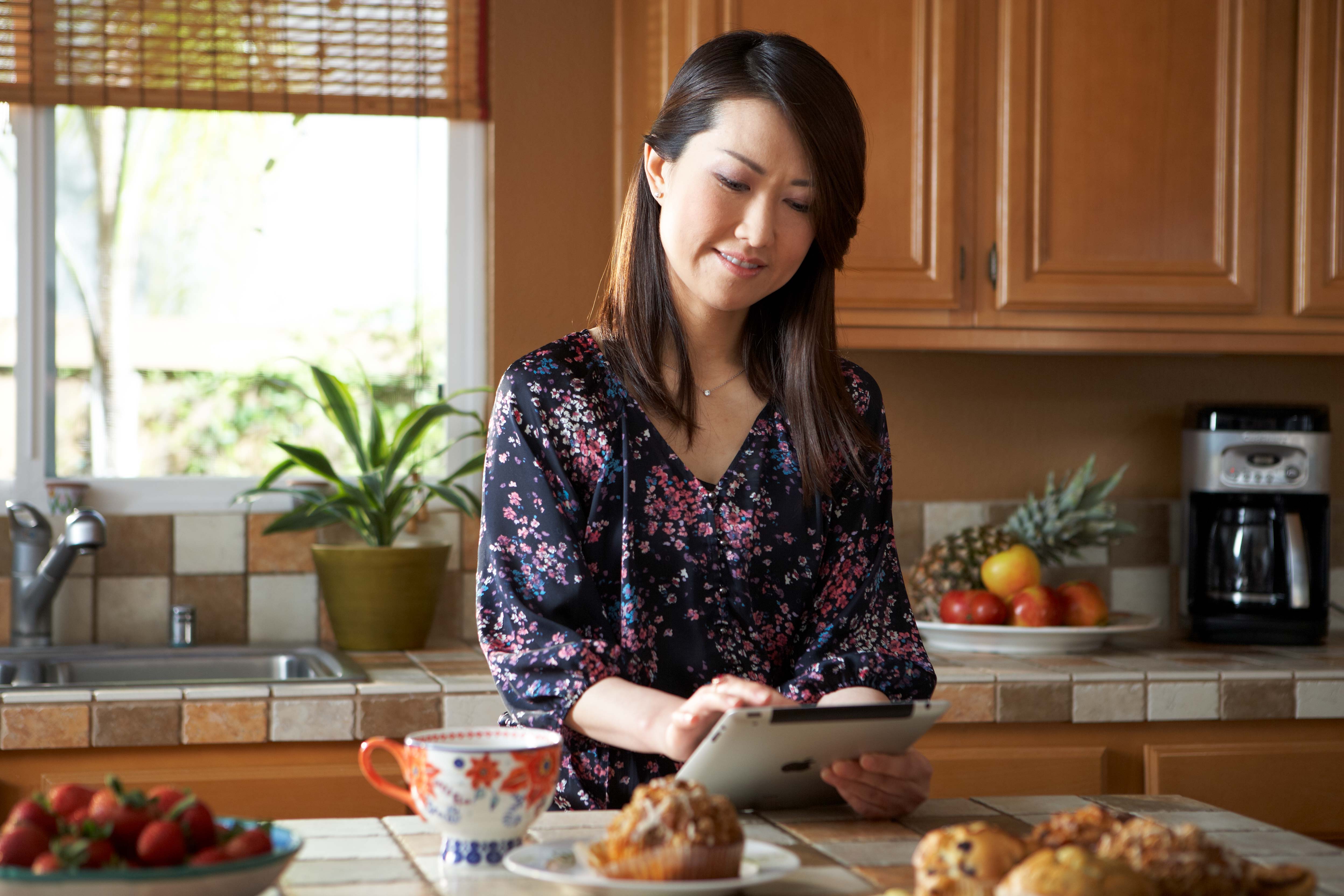 Woman on Tablet in Kitchen