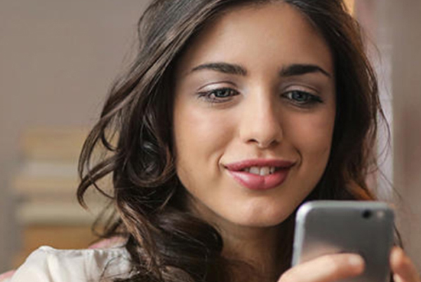 woman looking at mobile app on cell phone