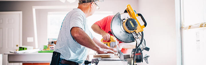 Men working with mitar saw