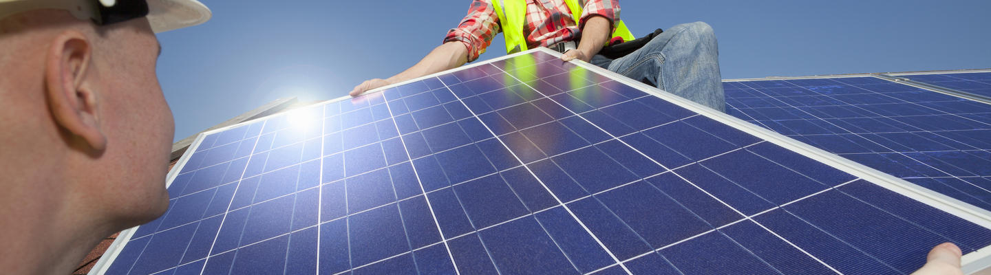 men installing solar panels