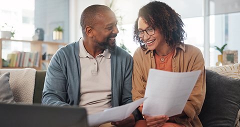 happy couple looking at bills